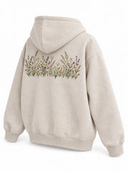 Rear three-quarter view of the Wild Meadow oatmeal embroidered hoodie