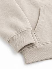Close-up of the cuff and hem rib of the Wild Meadow oatmeal embroidered hoodie