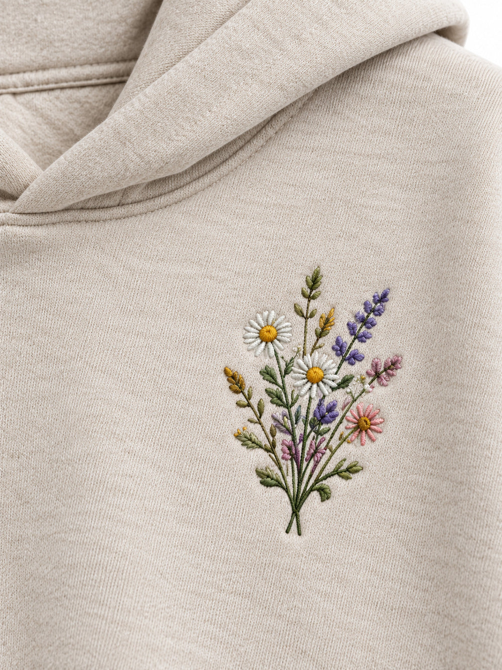 Close-up of the embroidered decoration on the Wild Meadow oatmeal embroidered hoodie