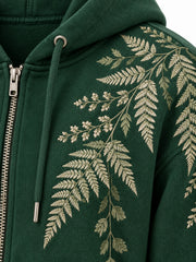 Close-up of the embroidered decoration on the Fern Spray forest green embroidered zip-up hoodie