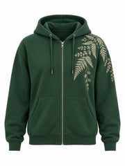 Front view of the Fern Spray forest green embroidered zip-up hoodie with cream-gold embroidered fern fronds trailing from the shoulder down the chest