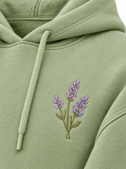 Close-up of the embroidered decoration on the Lavender Sprig pistachio embroidered cropped hoodie