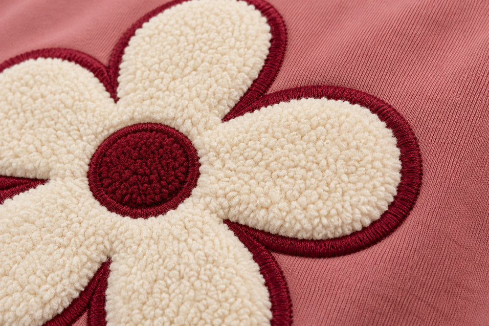 Close-up of the felt appliqué decoration on the Felt Bloom dusty rose felt appliqué hoodie