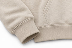 Close-up of the seam stitching of the Mountain Patch oatmeal felt appliqué hoodie