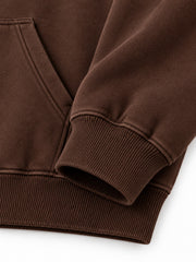 Close-up of the cuff and hem rib of the Velvet Fern chocolate brown flock print boxy hoodie