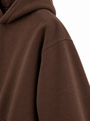 Close-up of the sleeve of the Velvet Fern chocolate brown flock print boxy hoodie