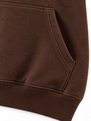 Close-up of the seam stitching of the Velvet Fern chocolate brown flock print boxy hoodie