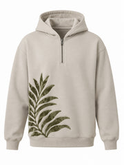 Front view of the Palm Frond stone flock print quarter-zip hoodie with olive flock palm frond rising from the lower left hem