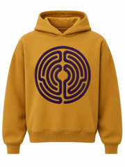 Front view of the Velvet Maze ochre flock print boxy hoodie with large plum flock labyrinth circle across the chest