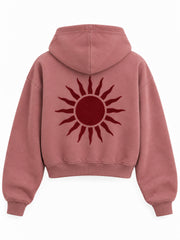 Back view of the Velvet Sun dusty rose flock print cropped hoodie with a large burgundy sun with radiating points