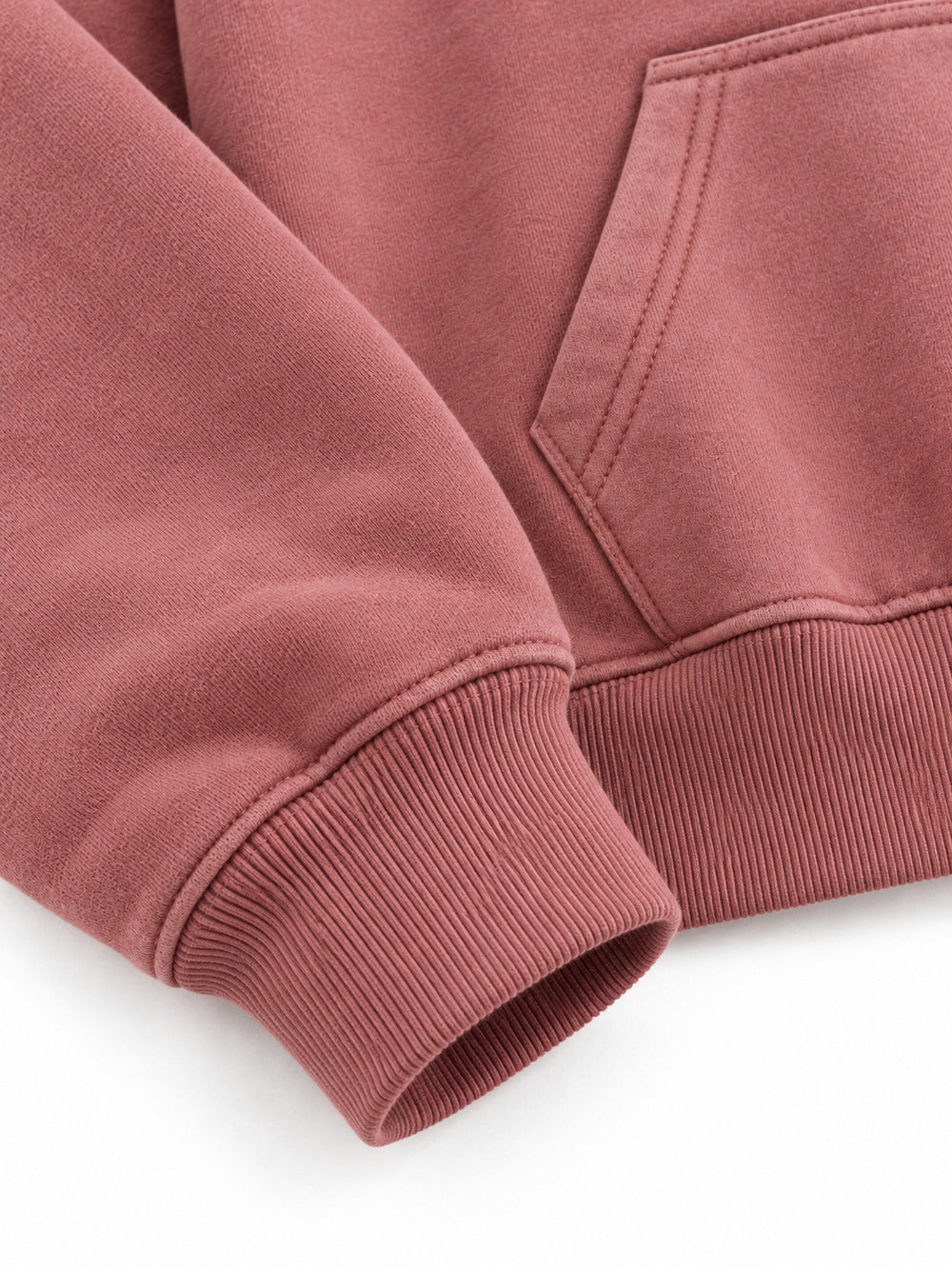 Close-up of the cuff and hem rib of the Velvet Sun dusty rose flock print cropped hoodie