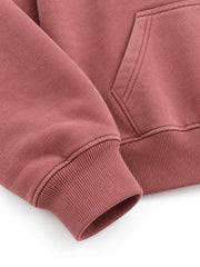 Close-up of the cuff and hem rib of the Velvet Sun dusty rose flock print cropped hoodie