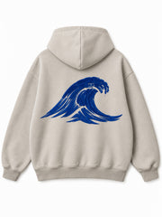 Back view of the Velvet Wave light stone flock print hoodie with a large cobalt-blue cresting wave