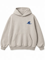 Front view of the Velvet Wave light stone flock print hoodie with a small cobalt-blue flocked wave at the left chest