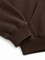 Close-up of the cuff and hem rib of the Copper Orbit espresso brown foil print oversized hoodie