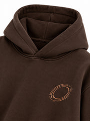 Close-up of the hood and neckline of the Copper Orbit espresso brown foil print oversized hoodie