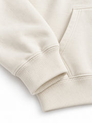 Close-up of the cuff and hem rib of the Gold Ginkgo cream foil print hoodie