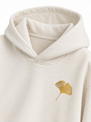 Close-up of the hood and neckline of the Gold Ginkgo cream foil print hoodie