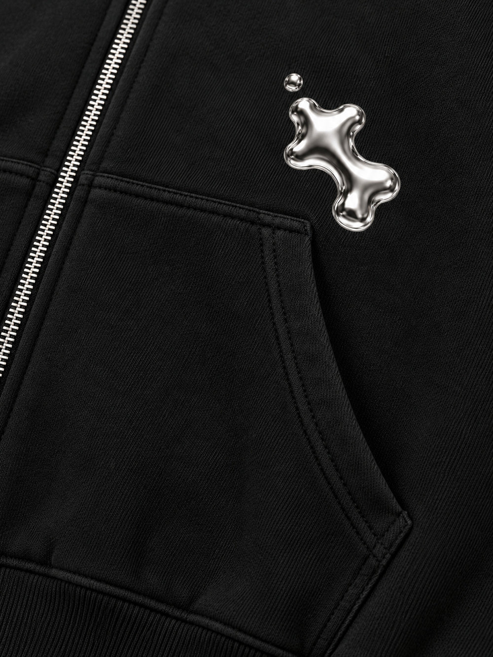Close-up of the seam stitching of the Liquid Silver black foil print zip-up hoodie