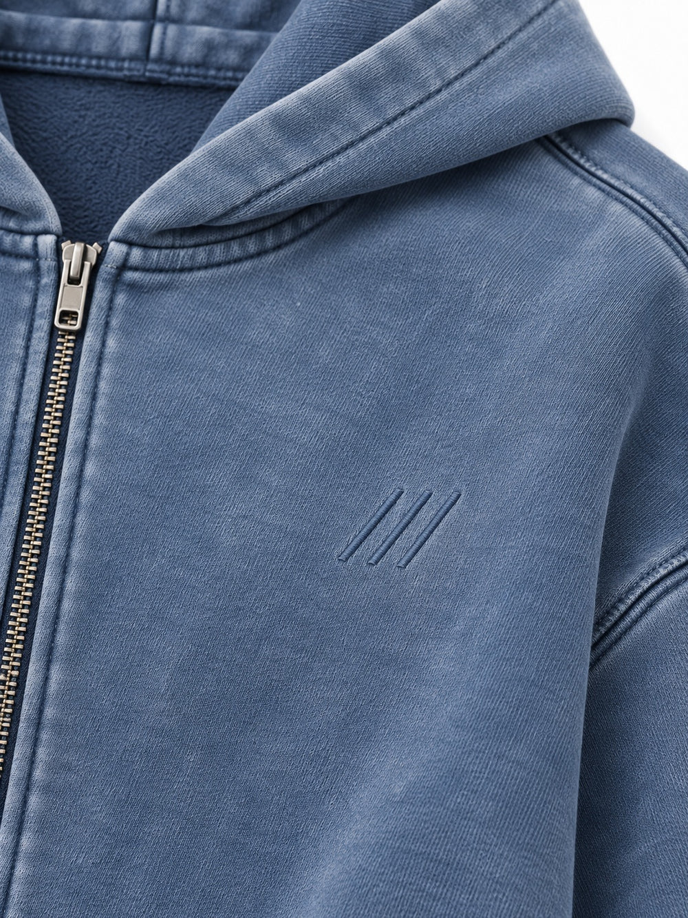 Close-up of the mineral wash decoration on the Quiet Motion slate blue mineral wash oversized zip-up hoodie