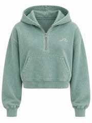 Front view of the Tide Mark seafoam mineral wash cropped half-zip hoodie with small cream embroidered wave on the left chest