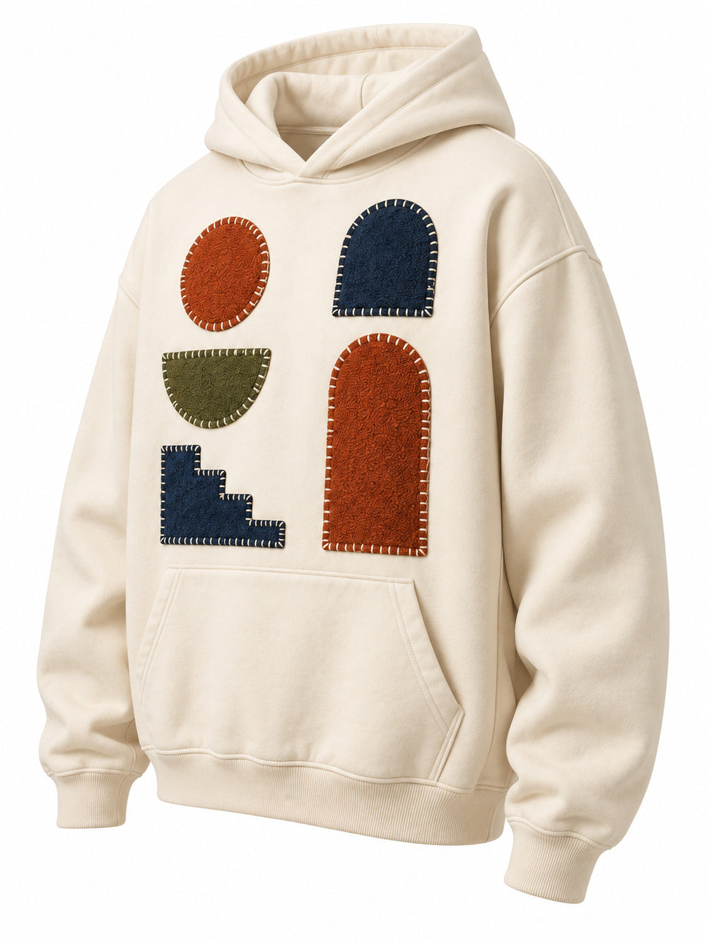 Front three-quarter view of the Patchwork Studio cream patchwork appliqué boxy hoodie