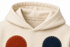 Close-up of the hood and neckline of the Patchwork Studio cream patchwork appliqué boxy hoodie