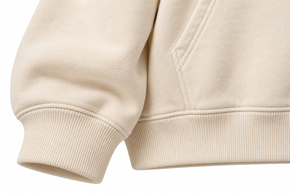Close-up of the seam stitching of the Patchwork Studio cream patchwork appliqué boxy hoodie