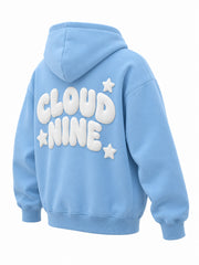 Rear three-quarter view of the Cloud Nine sky blue puff print oversized hoodie