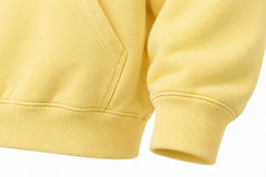 Close-up of the seam stitching of the Day Off butter yellow puff print hoodie
