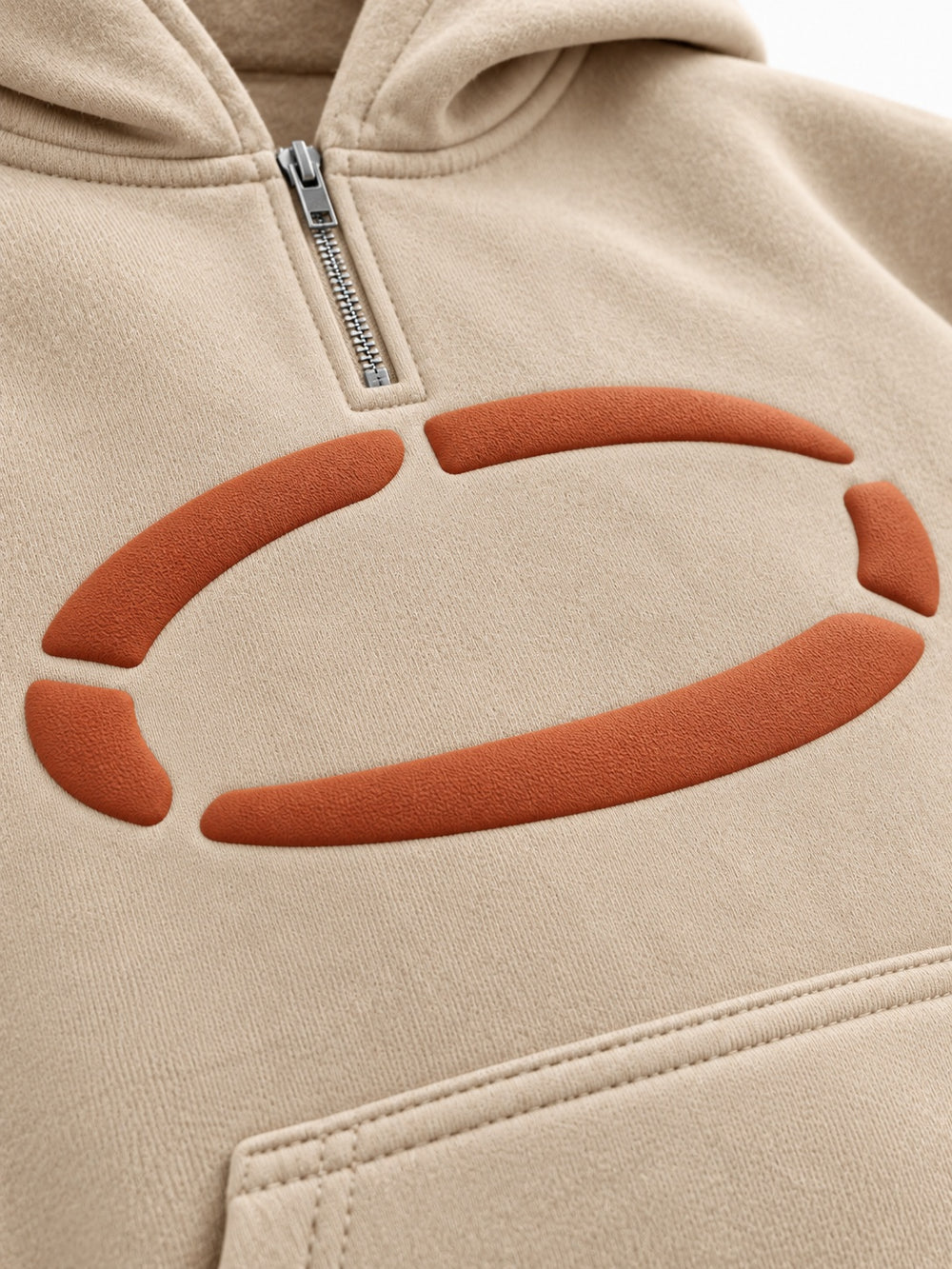 Close-up of the puff print decoration on the Dune Pulse sand puff print oversized quarter-zip hoodie