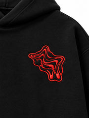 Close-up of the puff print decoration on the Lava Lines black puff print boxy hoodie
