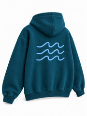 Rear three-quarter view of the Ocean Pulse deep teal puff print hoodie
