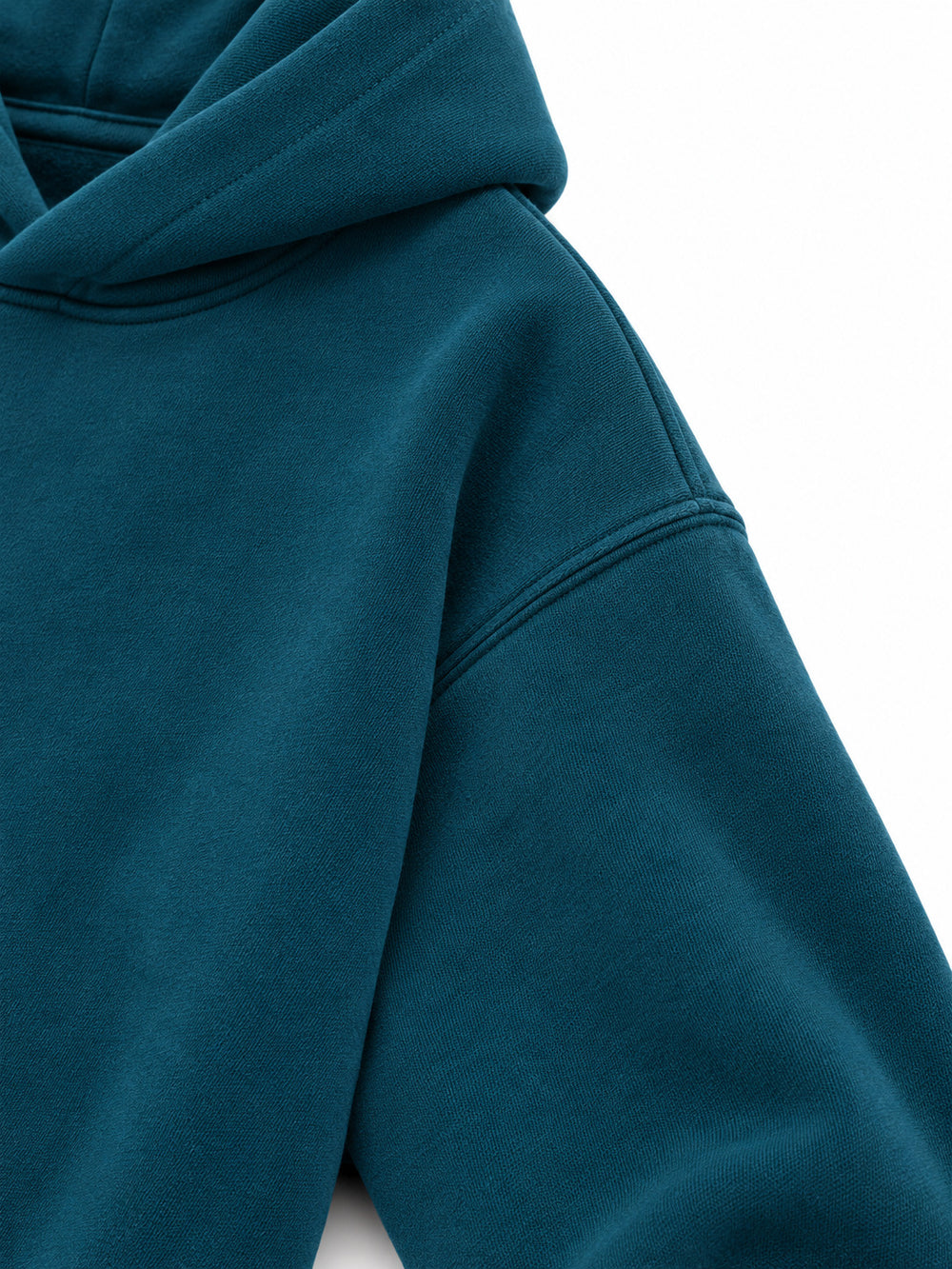 Close-up of the sleeve of the Ocean Pulse deep teal puff print hoodie