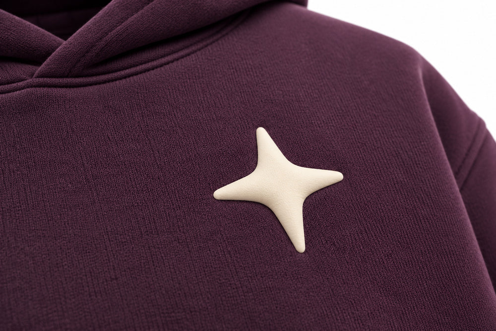 Close-up of the puff print decoration on the Orbit dark plum puff print oversized hoodie