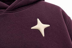 Close-up of the puff print decoration on the Orbit dark plum puff print oversized hoodie