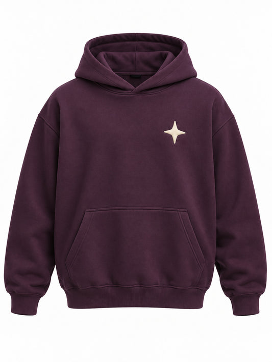 Front view of the Orbit dark plum puff print oversized hoodie with small cream four-point star in puff print