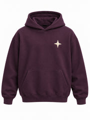 Front view of the Orbit dark plum puff print oversized hoodie with small cream four-point star in puff print
