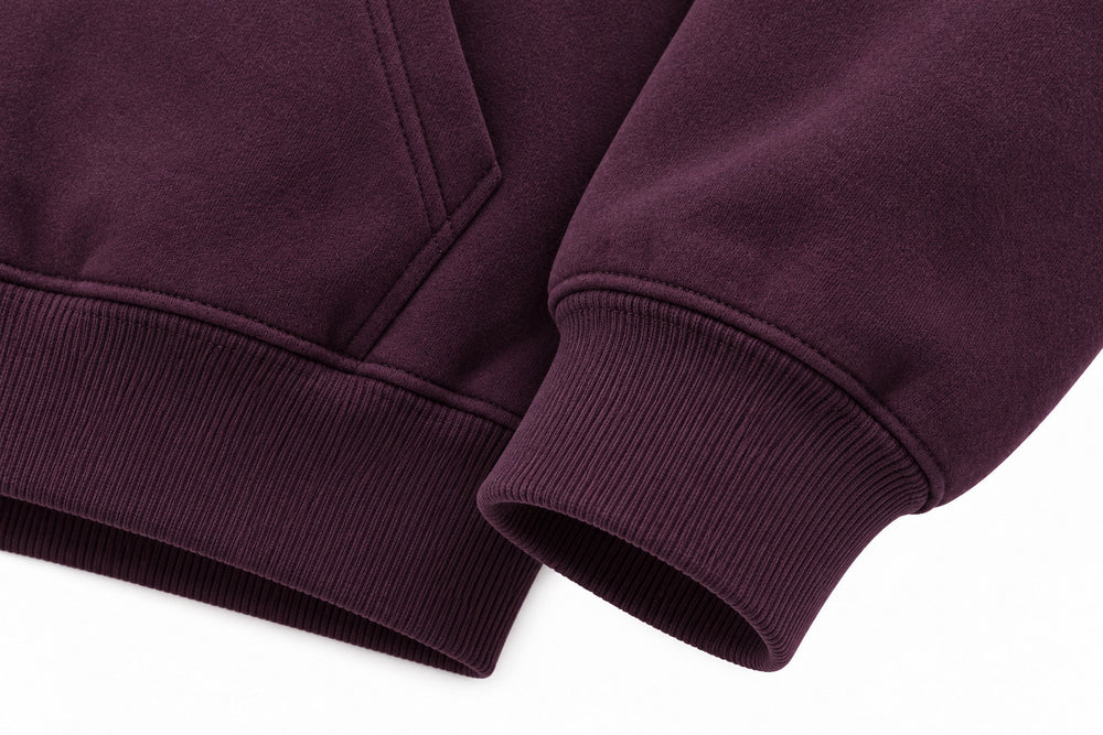 Close-up of the seam stitching of the Orbit dark plum puff print oversized hoodie