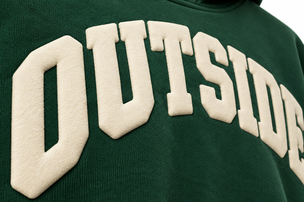 Close-up of the puff print decoration on the Outside pine green puff print hoodie