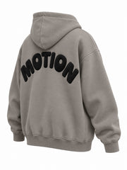 Rear three-quarter view of the Slow Motion warm gray puff print oversized hoodie