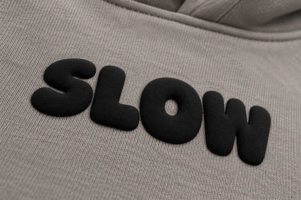 Close-up of the puff print decoration on the Slow Motion warm gray puff print oversized hoodie
