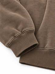 Close-up of the cuff and hem rib of the Soft Orbit washed mocha puff print oversized hoodie