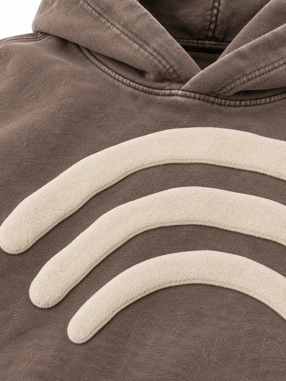 Close-up of the puff print decoration on the Triple Arc washed mocha puff print boxy hoodie