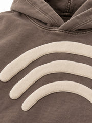 Close-up of the puff print decoration on the Triple Arc washed mocha puff print boxy hoodie