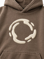 Close-up of the puff print decoration on the Soft Orbit washed mocha puff print oversized hoodie