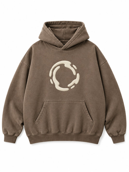Front view of the Soft Orbit washed mocha puff print oversized hoodie with a small cream broken-orbit puff graphic
