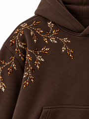 Close-up of the rhinestone decoration on the Crystal Vine espresso brown rhinestone boxy hoodie