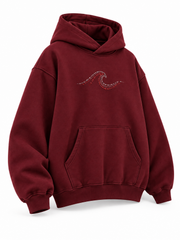 Front three-quarter view of the Ruby Waves burgundy rhinestone oversized hoodie