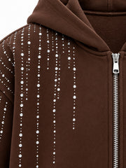 Close-up of the rhinestone decoration on the Silver Rain chocolate brown rhinestone boxy zip-up hoodie